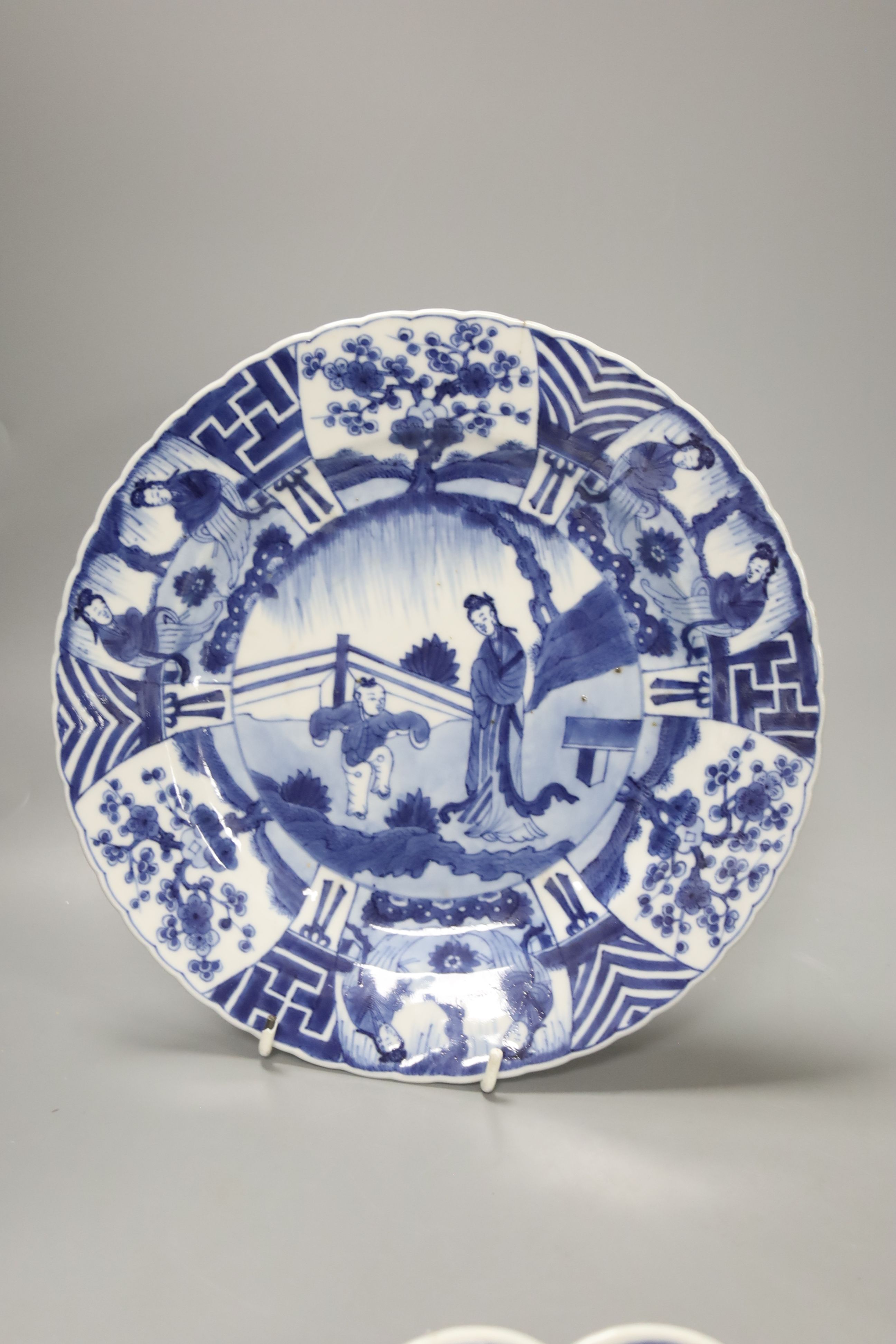 A Chinese Kangxi famille verte plate, decorated with a deer, a 19th century Chinese blue and white plate and an Imari scalloped dish, c.1850